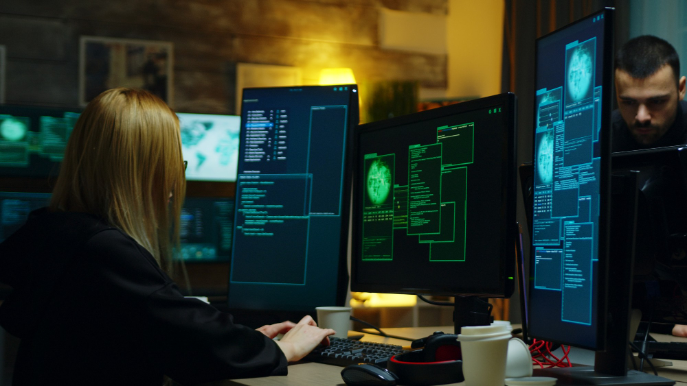 beautiful hacker girl working with another dangerous cyber criminals hackers centre